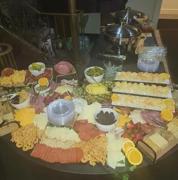Abundant meat and cheese grazing table by For Goodness Sakes